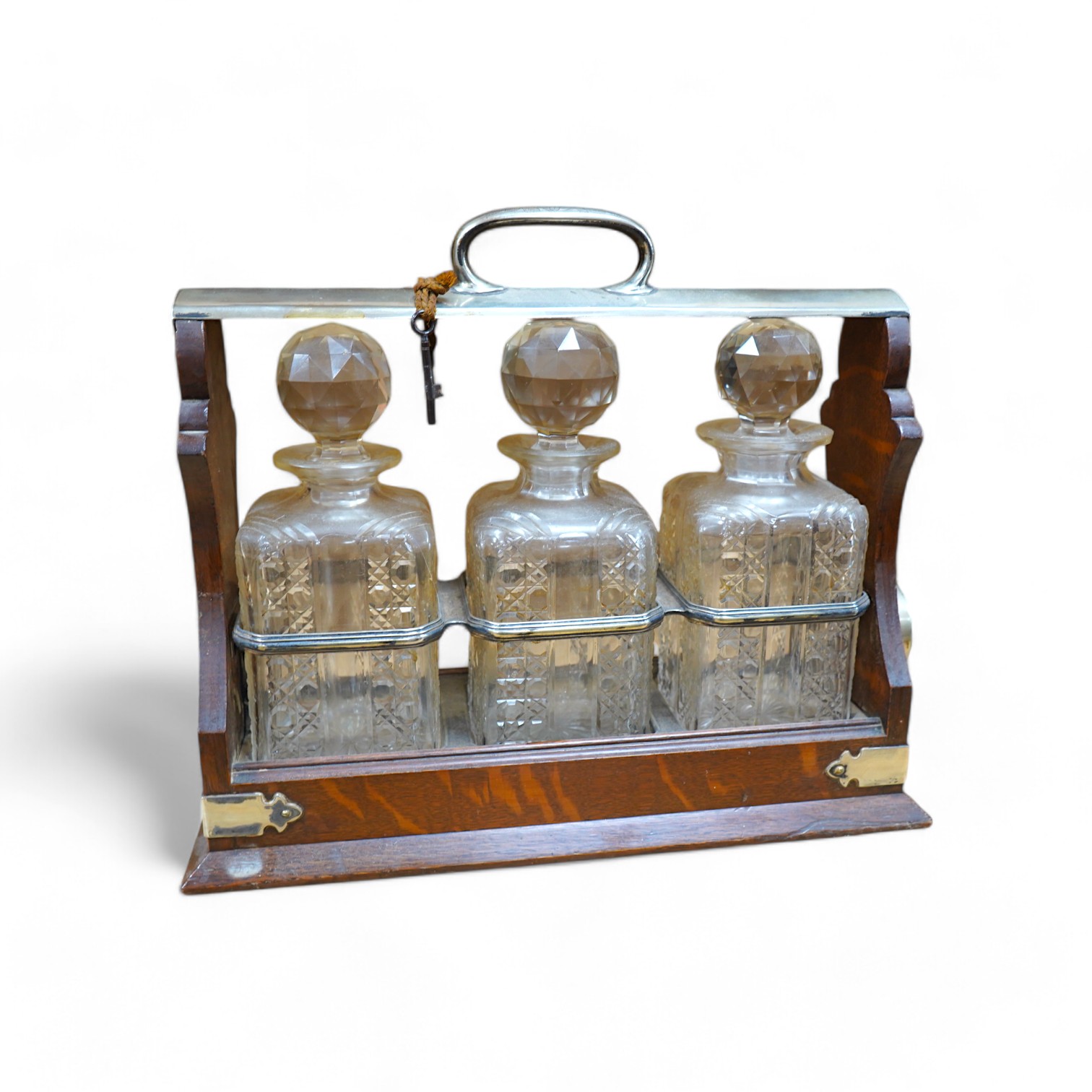 A Walker & Hall 'Hold Fast' oak three decanter tantalus, 40cm. Condition - fair